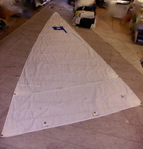 Small sail spread out on the floor of the loft.